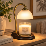 Aurora candle warmer lamp warming an unlit jar candle on a wooden side table