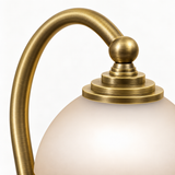 Close-up of the curved brass arm and shade fitting on the Aurora candle warmer lamp