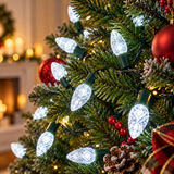 White strawberry LED Christmas lights displayed on a Christmas tree