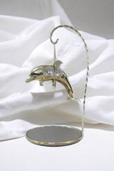 Gold-plated dolphin ornament with crystal detail and mirrored stand