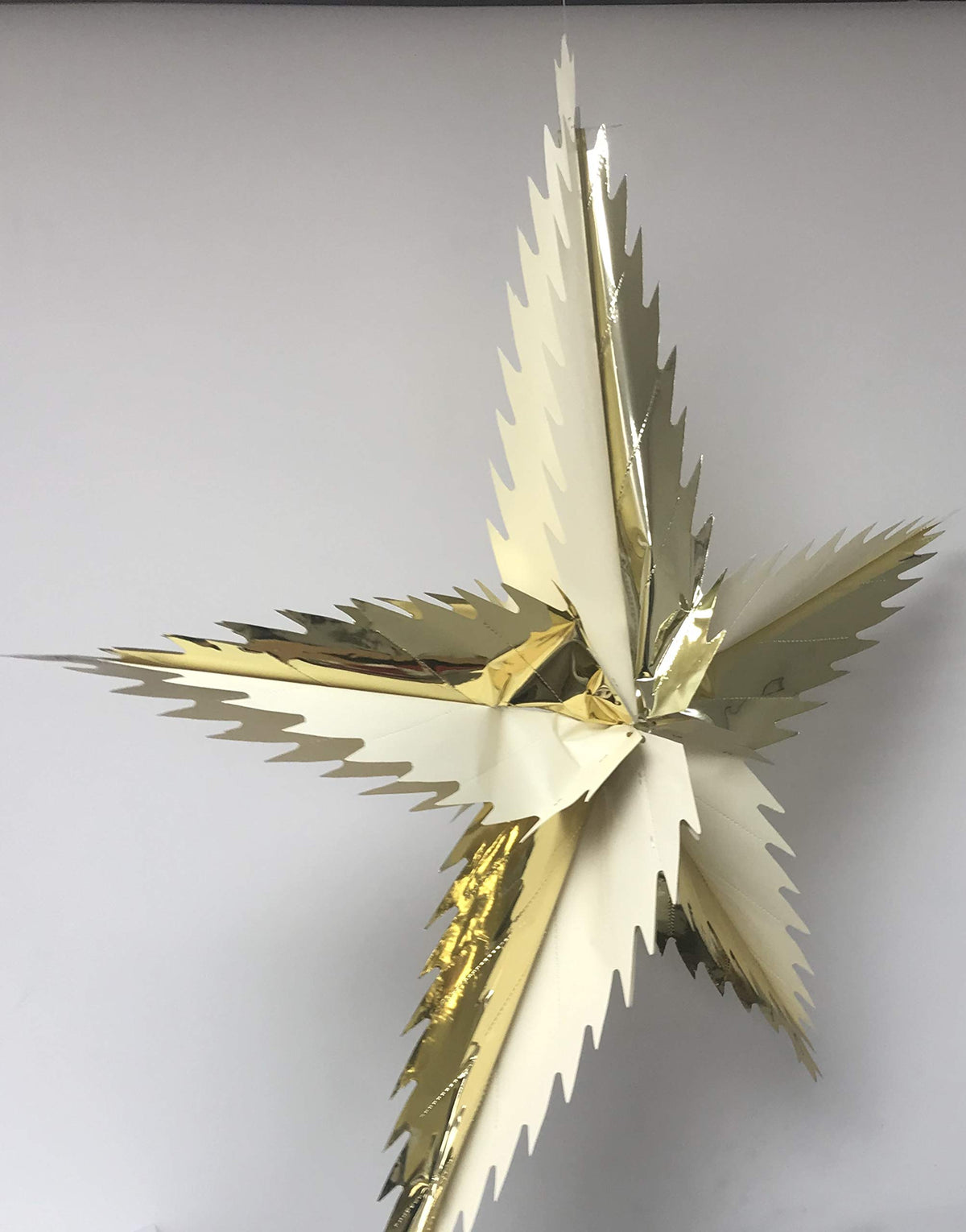 Cream and gold spiky star foil Christmas ceiling decoration