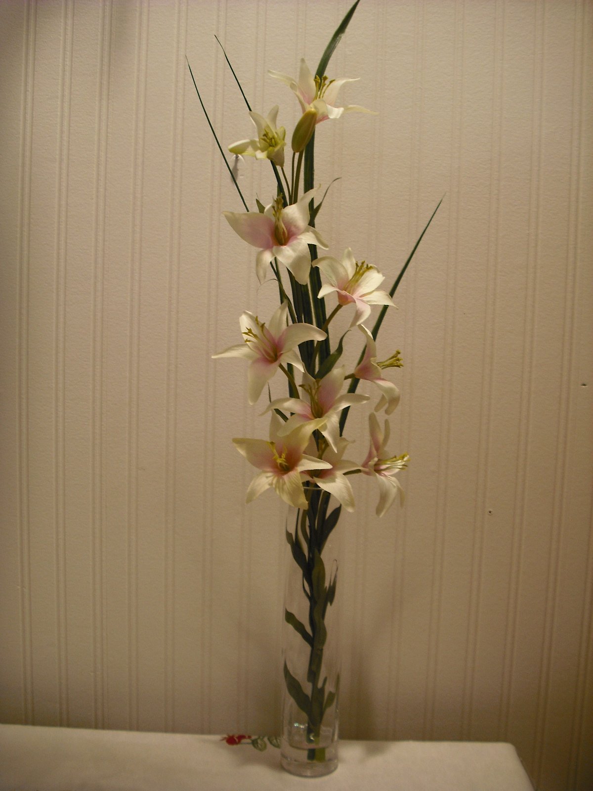 Artificial grass and lilies in spiral vase 70cm