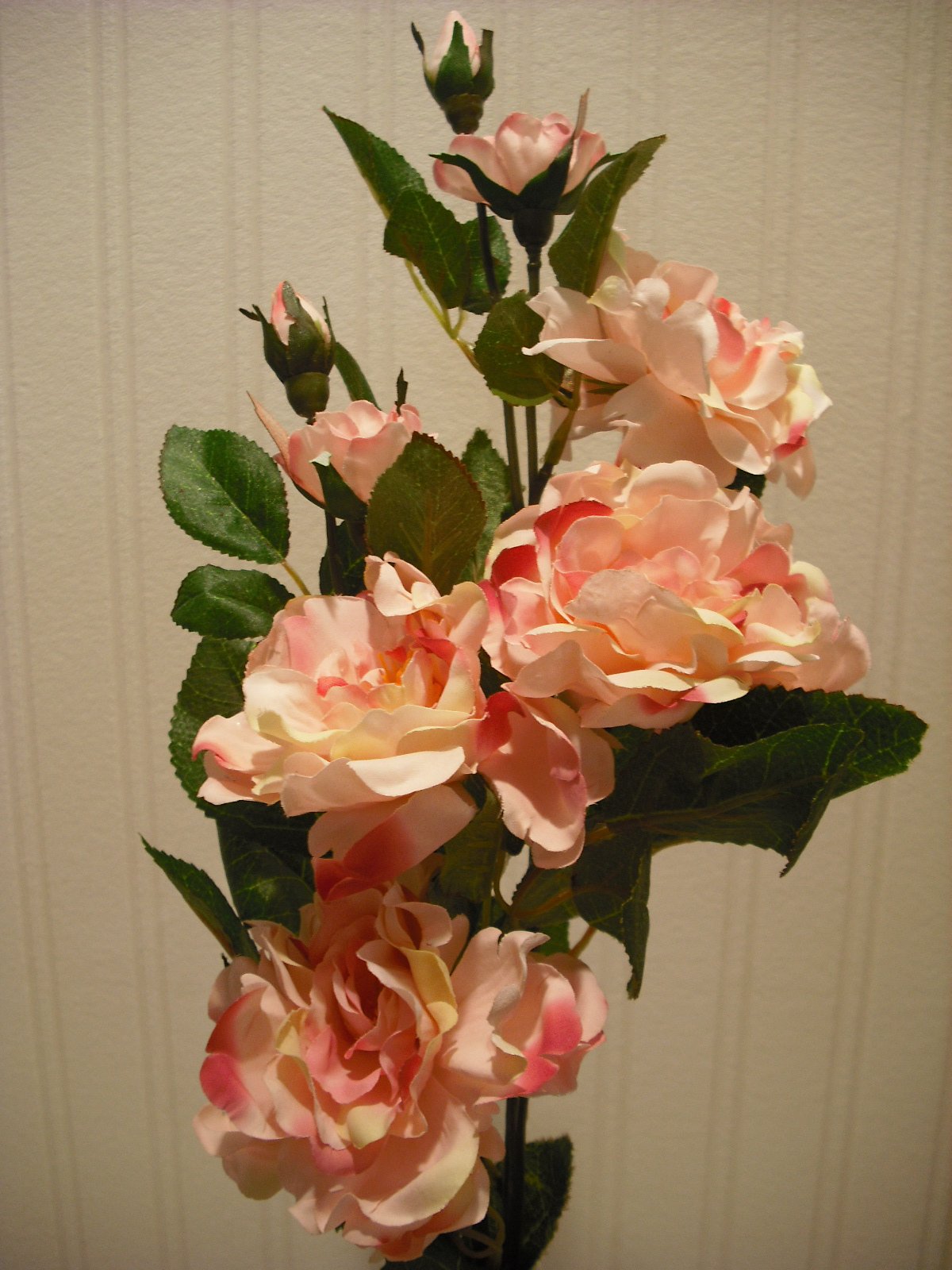 White artificial camellia flower arrangement in vase