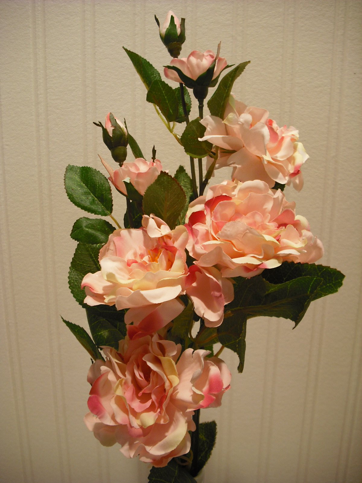 White artificial camellia flower arrangement in vase