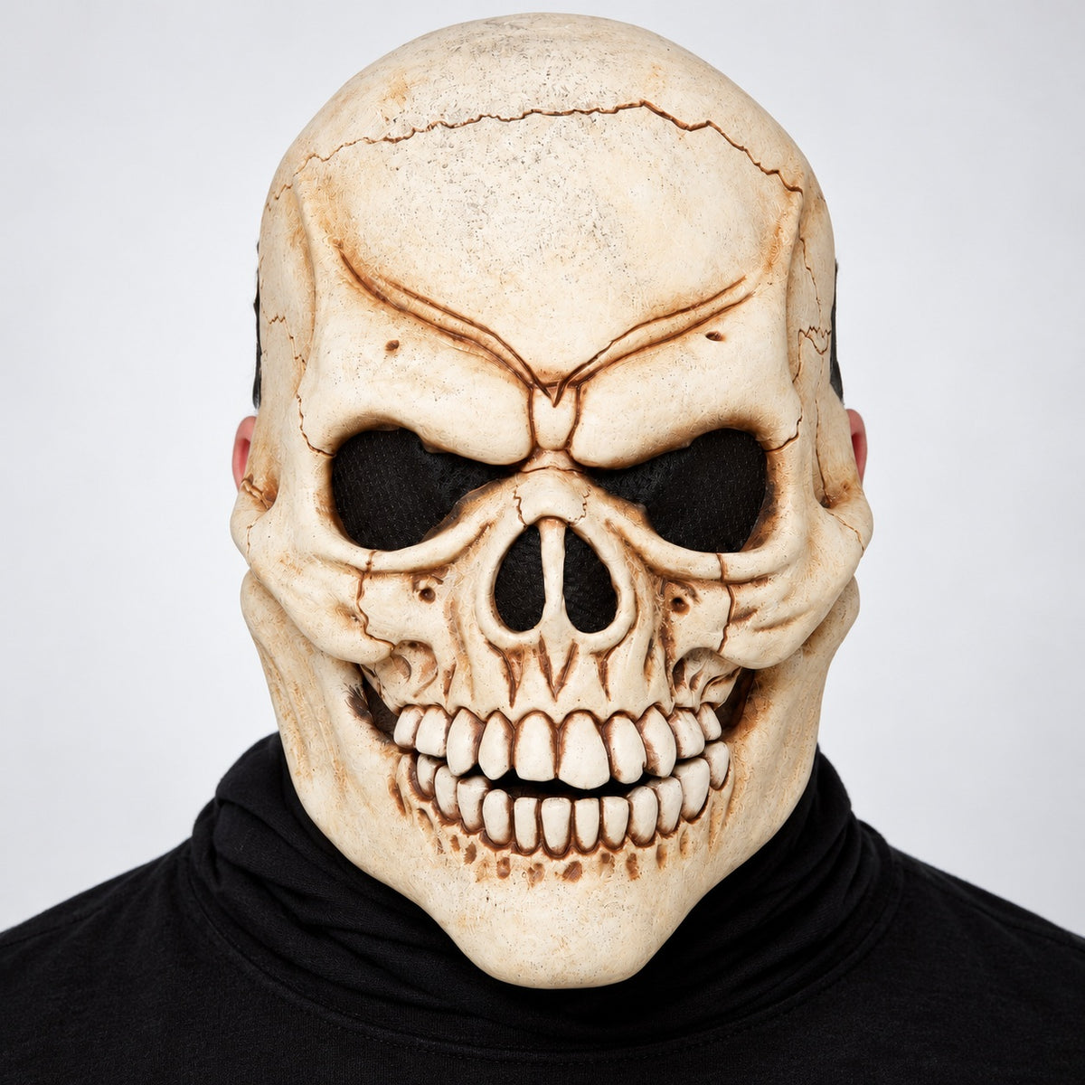 Illustrative adult model wearing Don Post skeleton skull face prosthetic with black costume