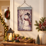 Frosty snowman metal wall hanging with lantern and Christmas greenery