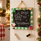 Green Christmas countdown chalkboard hanging in a festive home display