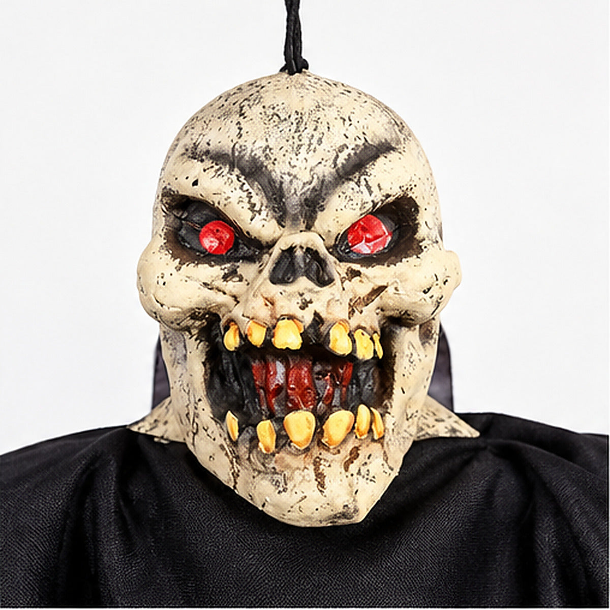 Hanging Ghoul Halloween rubber skull mask with red eyes and yellow teeth close up
