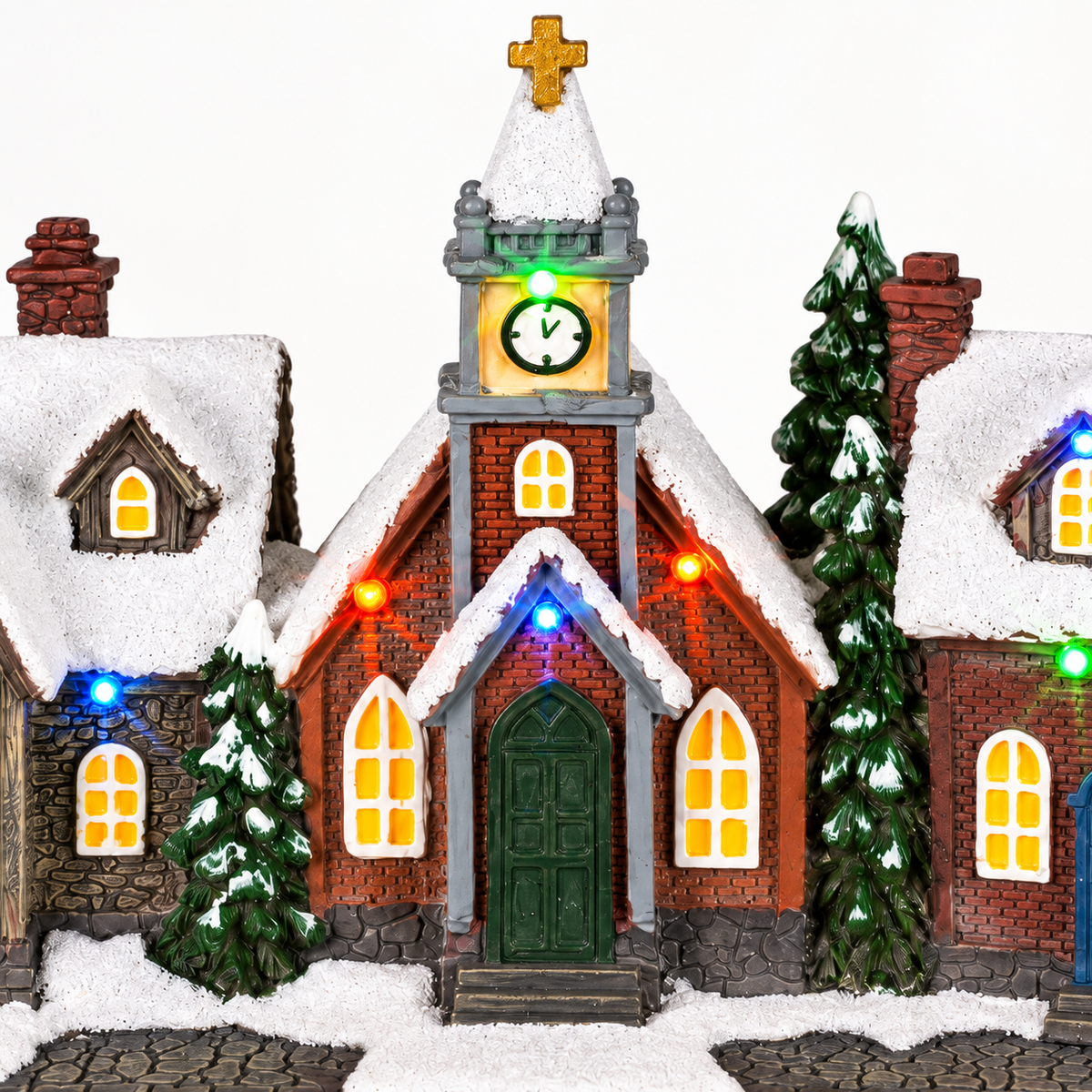 Close-up of LED Christmas village with houses church and snowy details