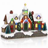 LED Christmas village with houses and church illuminated at night