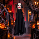SAW Jigsaw puppet hanging horror decoration in a Halloween haunted room with cobwebs lanterns and pumpkins