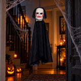 Jigsaw Billy puppet Halloween hanging decoration displayed in a spooky doorway with cobwebs and pumpkins