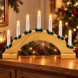 Wooden Christmas candle bridge with warm white LEDs on a festive mantel display