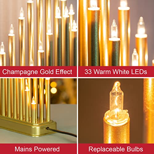 Illuminated champagne gold candle bridge for festive window display