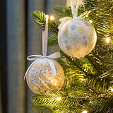 White and gold Christmas baubles with snowflake and icicle designs