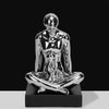 Silver ceramic cross-legged man with child figurine
