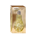 Gold LED lightbulb-style table lamp illuminated