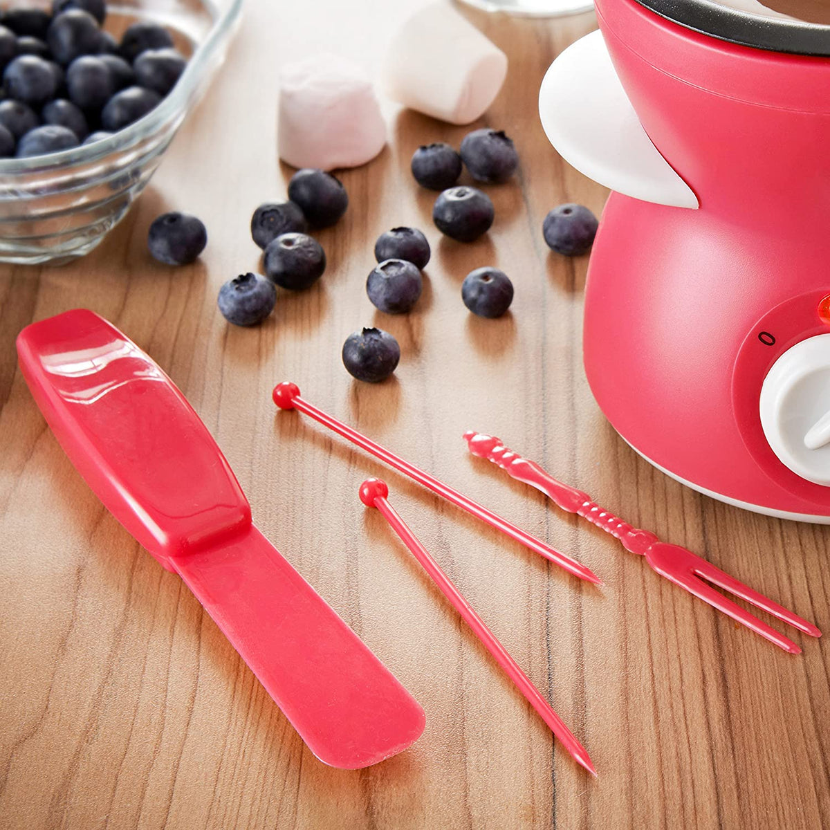 Compact red chocolate fondue pot with forks skewers and mould
