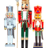 Three nutcrackers in different colors, each with a unique style, presented together for a festive display.