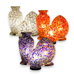 A collection of mosaic vases and egg lamps in various colours, showcasing unique designs and vibrant hues, arranged together on a surface.