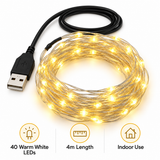 Warm white USB LED string lights illuminated in a night-time indoor display