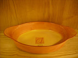 Brown oval ovenproof casserole baking dish with handles