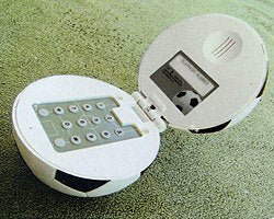 Novelty football-shaped telephone with hidden keypad