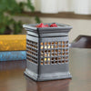 Candle Warmers Etc Illumination Candle Warmer, Quadra, on a table, featuring a soft glow with a candle inside, enhancing home décor ambiance.