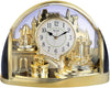 Rhythm gold and black mantel clock with rotating crystal pendulums