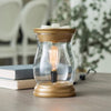 Edison Style Illumination Fragrance Warmer with curved glass and exposed filament bulb on a table, ideal for warming scented wax melts.