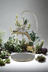 Gold-plated dolphin ornament with crystal detail and mirrored stand