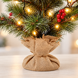 Close-up of hessian sack base and lower frosted branches on 60cm pre-lit mini Christmas tree