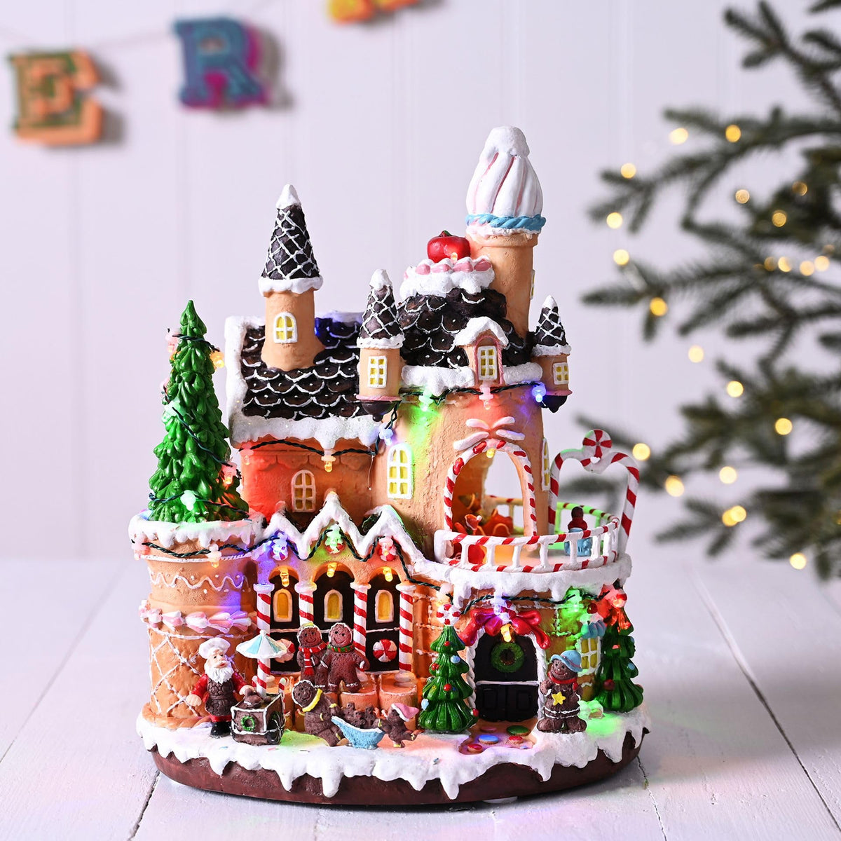 30cm battery-operated LED gingerbread house with rotating characters
