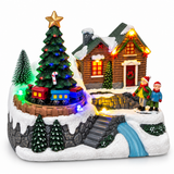 Illuminated Christmas village with revolving train, tree and snowy house