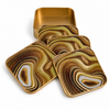 Set of four gold brown and cream sand swirl glass coasters with matching gold metal holder on white background