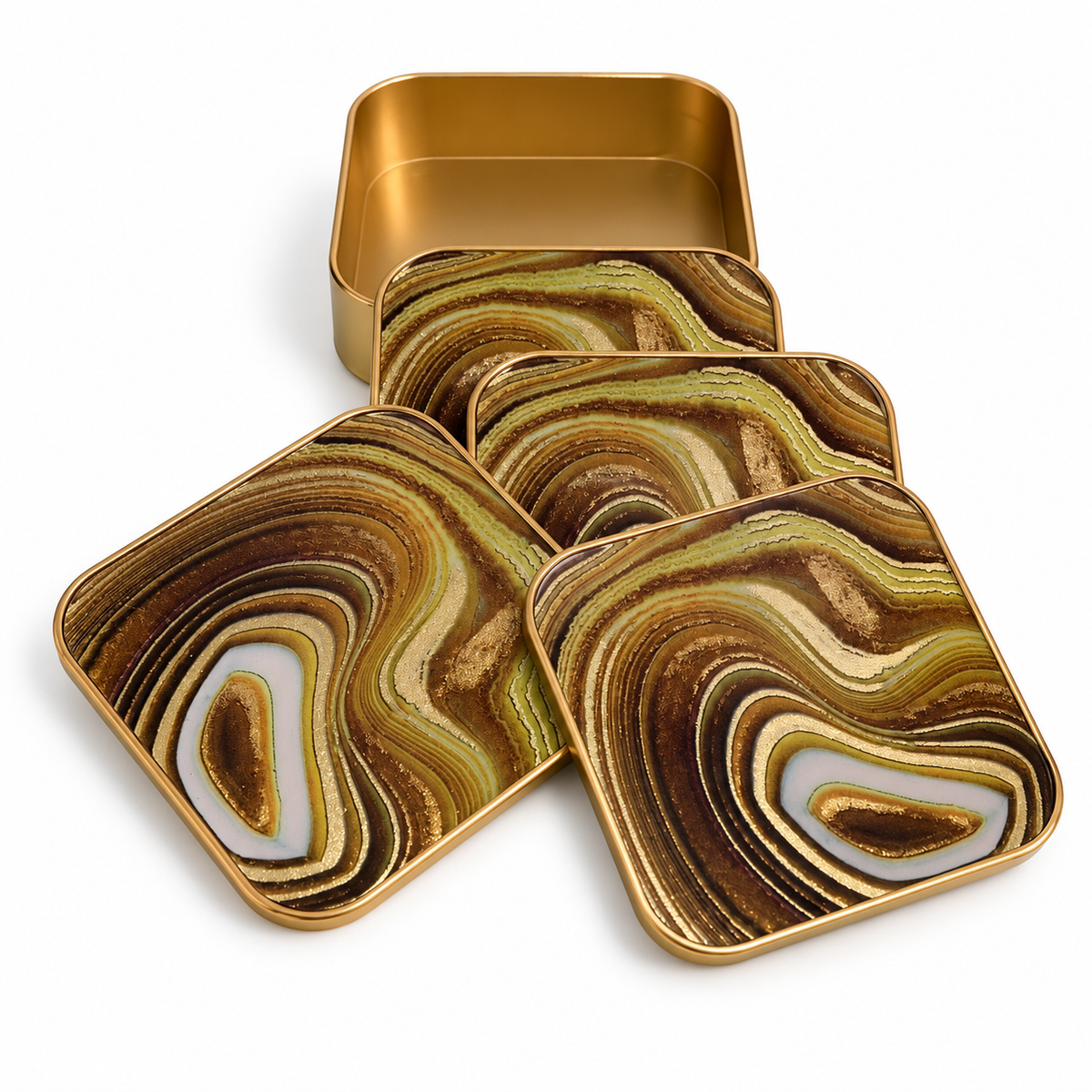 Set of four gold brown and cream sand swirl glass coasters with matching gold metal holder on white background