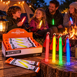 Illustrative camping evening scene showing neon glow sticks in red yellow green and blue