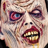 Close-up of Putrid Halloween zombie mask with wrinkled face and rotten teeth
