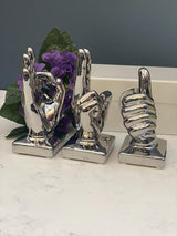 Three chrome-plated ceramic hand ornaments displayed together
