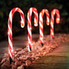 Set of four red and white LED candy cane Christmas path lights