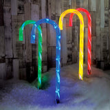 Four multicoloured LED candy cane Christmas stake lights
