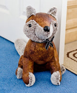 Brown fox animal door stop in a home setting